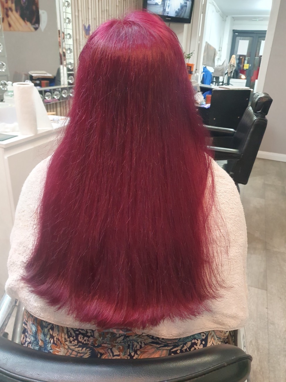 A glossy magenta colour and sleek blow-dry finished at Tahira's Hair and Beauty