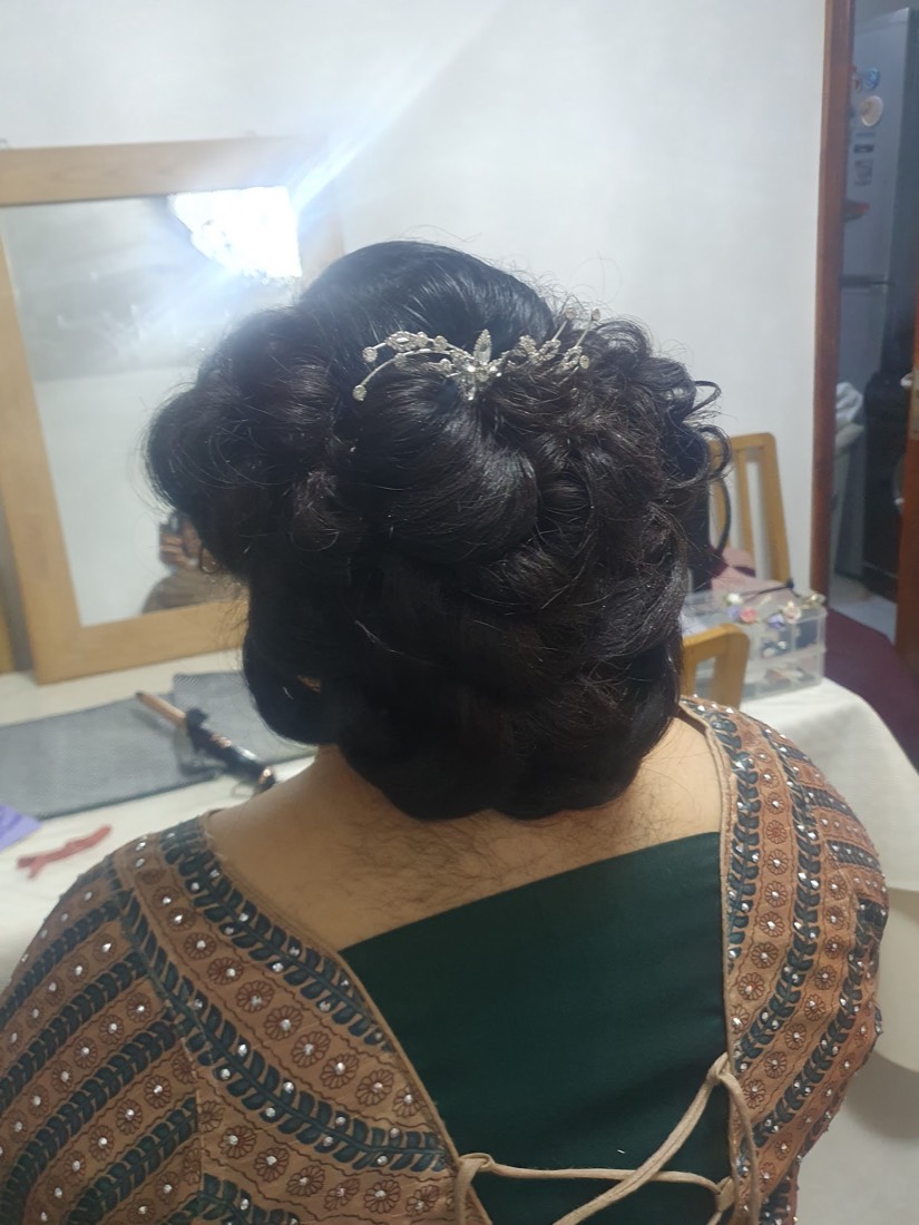 A bridal updo set with crystal hair jewellery, styled at Tahira's